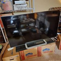 Vizio 50-inch TV powered off on stand in room