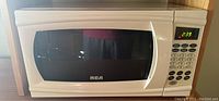 Closed microwave displaying RCA brand and digital keypad showing 2:39