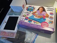 Photo showing a boxed Pottery Cool kids clay making set featuring a pottery wheel and a Lite-Brite toy pegboard with pegs.