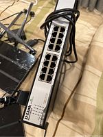 D-Link DGS-1008D gigabit switch showing 8 Ethernet ports, LED indicators, and power cable.