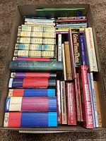 Box view showing assorted hardcover Harry Potter books and vintage mystery paperbacks packed together