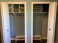 Closet spaces showing white wooden storage shelves installed inside closet interiors, with open doors.