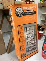 Boxed unopened steel shelving unit with 6 shelves marked medium-duty and capacity details.