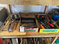Shelving with boxes containing tools and electronic ballasts including Turbo Shear and various screwdrivers.