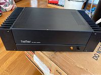 Front view of the Hafler DH-200 stereo power amplifier showing black metal chassis and front panel