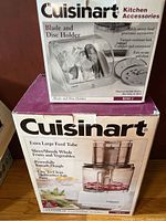 Box of Cuisinart Custom 14 food processor and box of Cuisinart Blade and Disc Holder BDH-2 stacked, details of box features visible