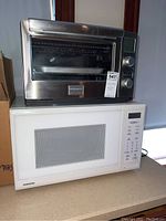 Front view showing Samsung microwave under Frigidaire toaster oven on countertop