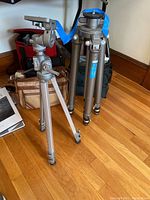 Photo showing both Velbon VS-3 and 505 Telestudex tripods standing on a hardwood floor near bags.