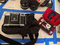 Photo showing Zeiss Ikon film camera and Rolleikin parts in case