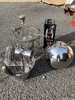 Photo showing metal ice bucket set including lid, metal frame for larger ice bucket, cocktail tool bucket and bottled with attached base, plus boxed Vinturi wine aerator.