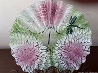 Glass fan-shaped platter with textured flower pattern in pink and green