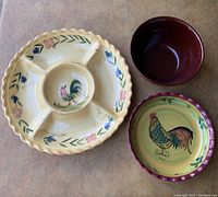 Top view of all three pieces showing rooster design on platter and pie plate, solid brown ceramic bowl.