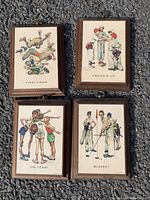 Four small wooden framed vintage sports illustrations hung on a rough textured wall, showing each piece clearly and the overall lot setup.