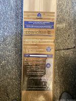 Photo of sealed CanWel Cowichan cedar wood panelling pack, showing label with product details, dimensions, and coverage area.