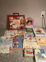The assortment of children's books displayed, including the travel suitcase set and various illustrated storybooks.