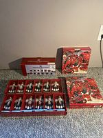 Overview of all items in the lot including nutcracker place card holders, dessert plates, and picture frames.