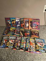 Overall view of the lot showing all Goosebumps and Captain Underpants books arranged on the floor.