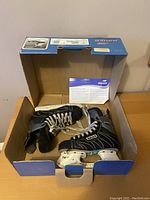 Pair of black Bauer Supreme 3.0 youth hockey skates with white laces in original blue Bauer box. Includes product paperwork.