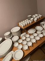 Wide view of plates, bowls, cups and saucers arranged on tables