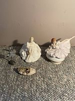 Full view of all items: Royal Doulton doll, musical ballerina, slipper, and silver ballet figurine.