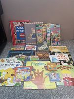 Photo showing a collection of 20 young children's books with colorful covers and a variety of educational and story themes.