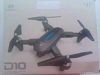 Front of the DEERC D10 drone package showing drone image with four propellers and model identification.