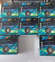 Six Flying Ball toys in original sealed boxes arranged in two rows of three and one separate box.