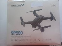 Image of Snaptain SP500 box front showing drone image and key features