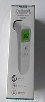Front view of the white forehead thermometer box showing product image and features like one-second reading and clinical accuracy.