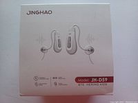 Front of Jinghao JH-D59 hearing aids box with images of the two earpieces and model info.