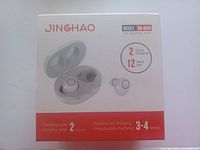 Front packaging image showing the JINGHAO JH-A39 hearing aids with charging case illustration and charging time details.