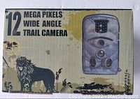 Photo of the product box showing 12 megapixels wide angle trail camera with camouflage pattern, multiple lenses and LED lights.