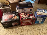 Photo showing all boxed items: Brita jug and filters, punch bowl set, freezer shelves, CO sensor, and boxed wine glasses.