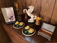 Photo showing white horse figurine with repaired front legs, two yellow rose chalkware plaques, various candleholders including in box, and small wooden and hinged lid boxes.