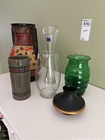 Full set of six vases in various materials and styles.