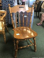 Medium-tone wood Ethan Allen side chair with turned legs, spindled backrest with cut-out handle at top.