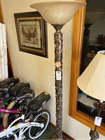 Full view of the heavy molded metal floor lamp showing its intricate design and height near 72 inches.