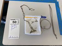 Full view of all jewelry items including the whale tail necklace, whale tail earrings, dolphin bracelet, and chain bracelet on a white mat background