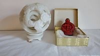Whole lot view showing the white jade dragon sphere puzzle and cinnabar snuff bottle side by side in presentation box with cushioning