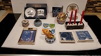 Overhead view of full lot displaying plates, vases, trays, candle holders, and various ceramic items.