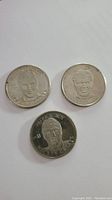 Three silver-colored round hockey souvenir coins, each featuring a different player portrait and details.