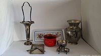Overview of the full lot showing all items including clay plant pot, Pimpernel tray, pewter vase, silver plated items.