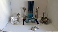 Full lot of decorative and functional items including ceramic vase, metal candle holders, ceramic vases, metal plate, turtle tealight holder, Koka dish, London bell.