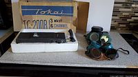 Tokai TC-2008 transceiver in original box and three pairs of vintage goggles with removable eyepieces