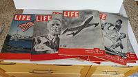 Eight Life magazines with various July-August 1945 covers showing age wear on edges and corners.