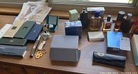 Full overview of lot items arranged on wooden surface under window