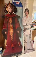 Full view of both life size cardboard cutouts of Padmé Amidala and Luke Skywalker with Pepsi logo visible