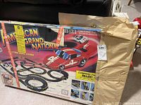 Original box for Marchon American Grand National electric road racing toy showing front artwork, including images of red and white racing cars, track layout, and branding.