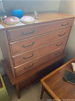 Front view of four-drawer dresser on matching base
