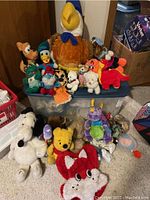 Overall view of all plush toys together showing the variety and condition.